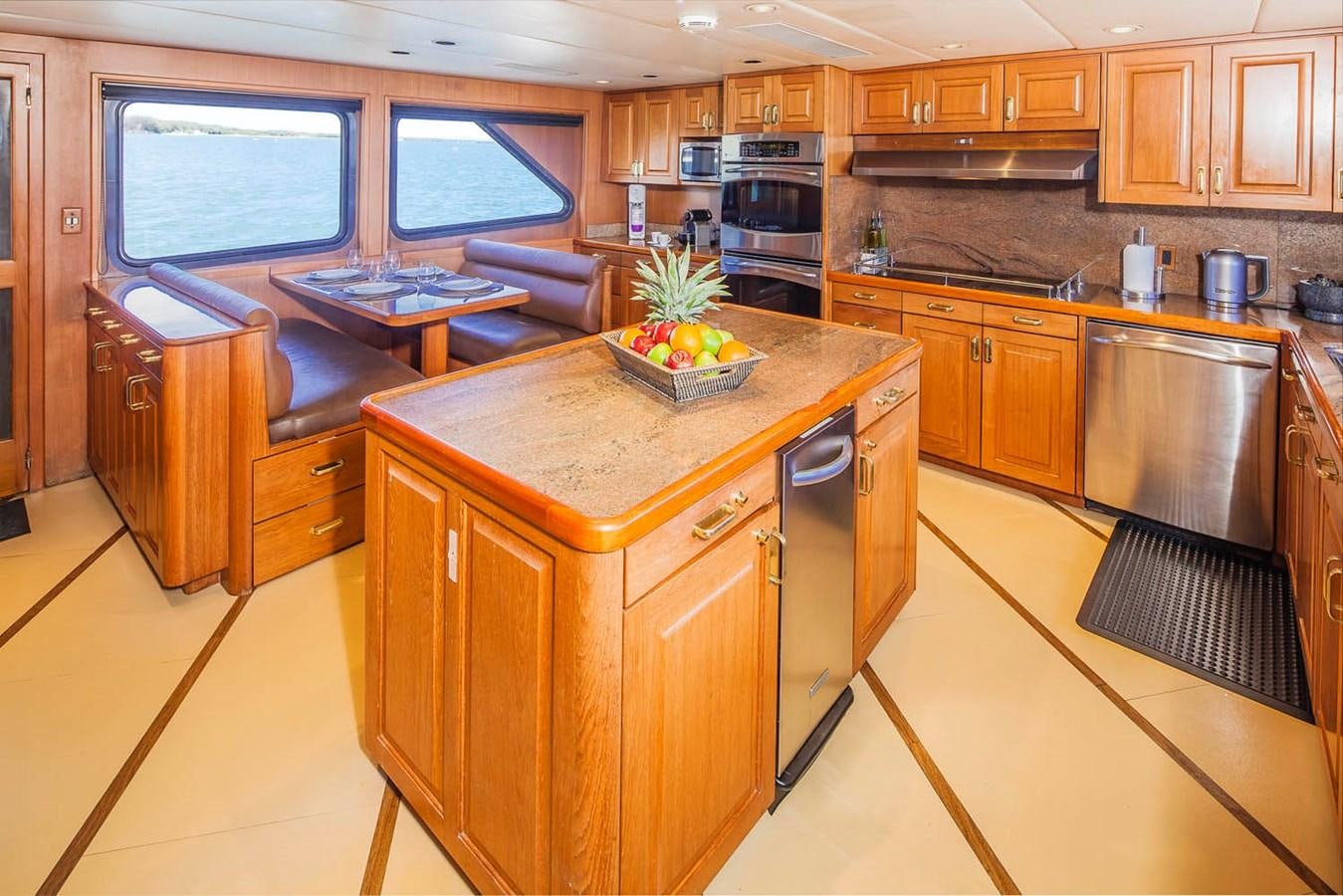 a kitchen with wooden cabinets aboard SILENT WORLD II Yacht for Sale