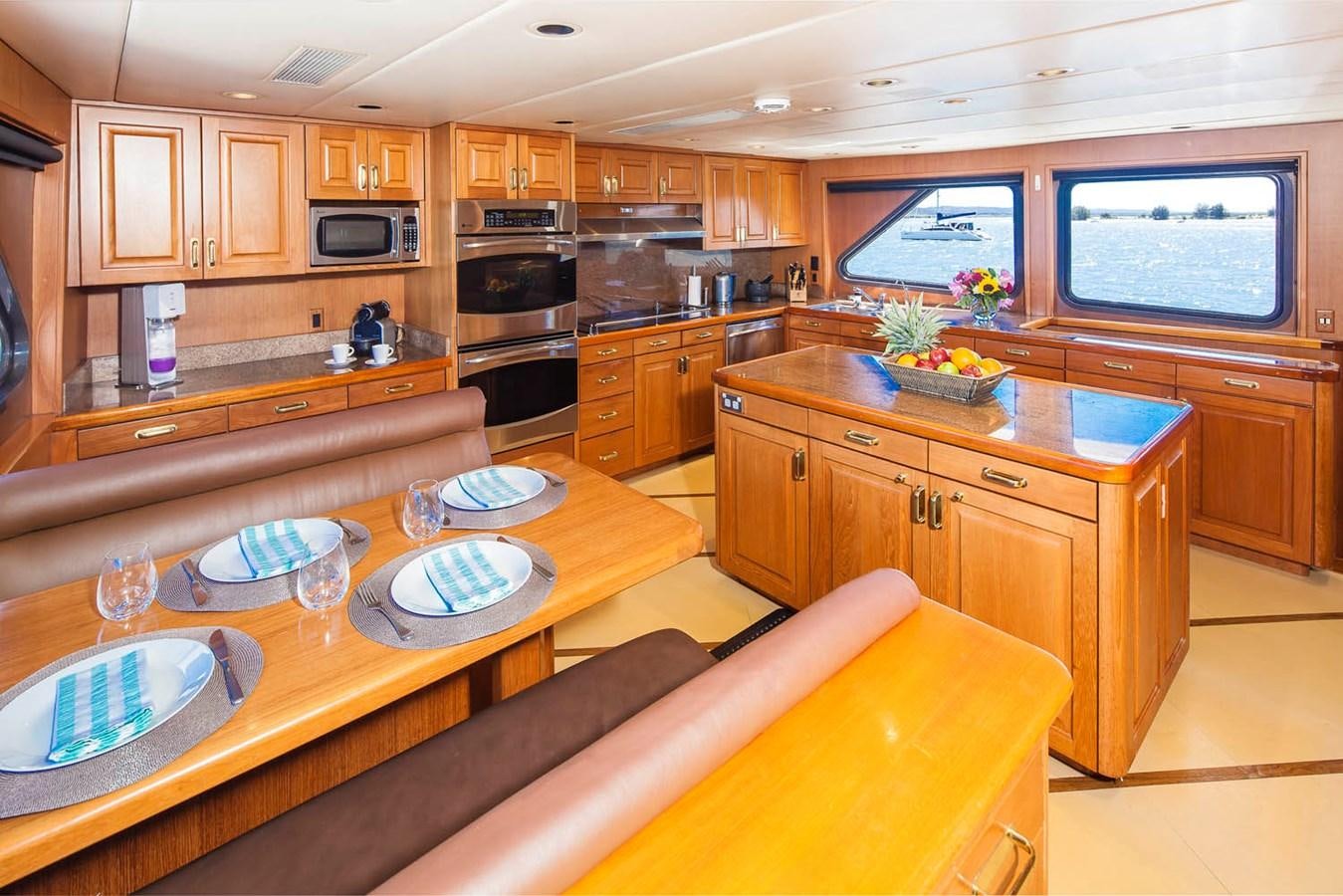 a kitchen with wooden cabinets aboard SILENT WORLD II Yacht for Sale