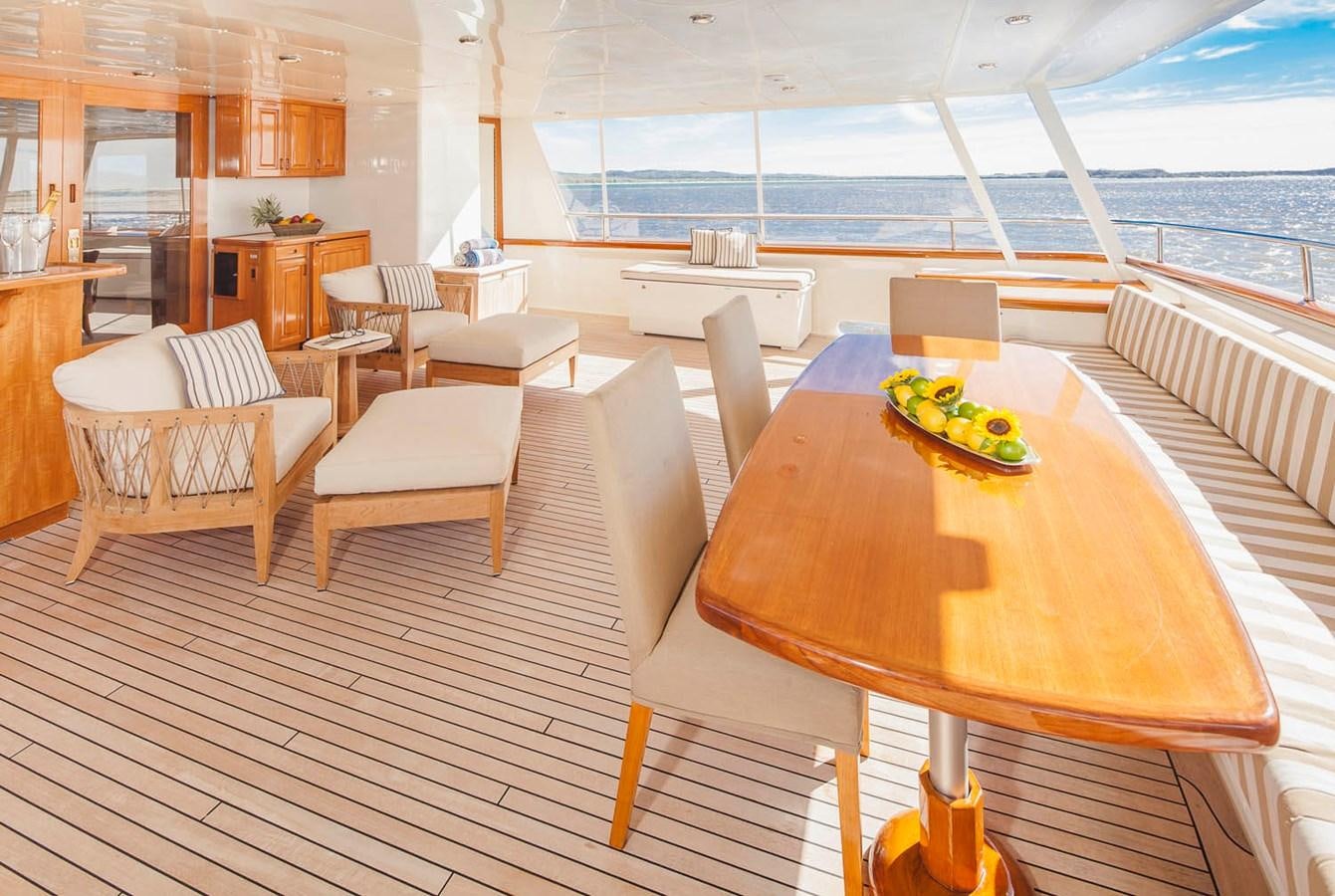 a room with a table chairs and a large window aboard SILENT WORLD II Yacht for Sale