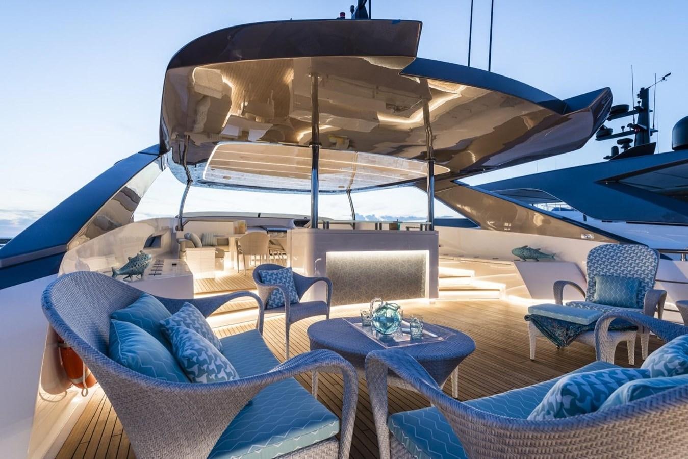 a large lounge chair next to a large umbrella aboard HARMONY Yacht for Sale
