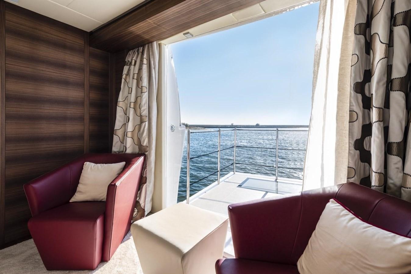 a room with a balcony aboard HARMONY Yacht for Sale