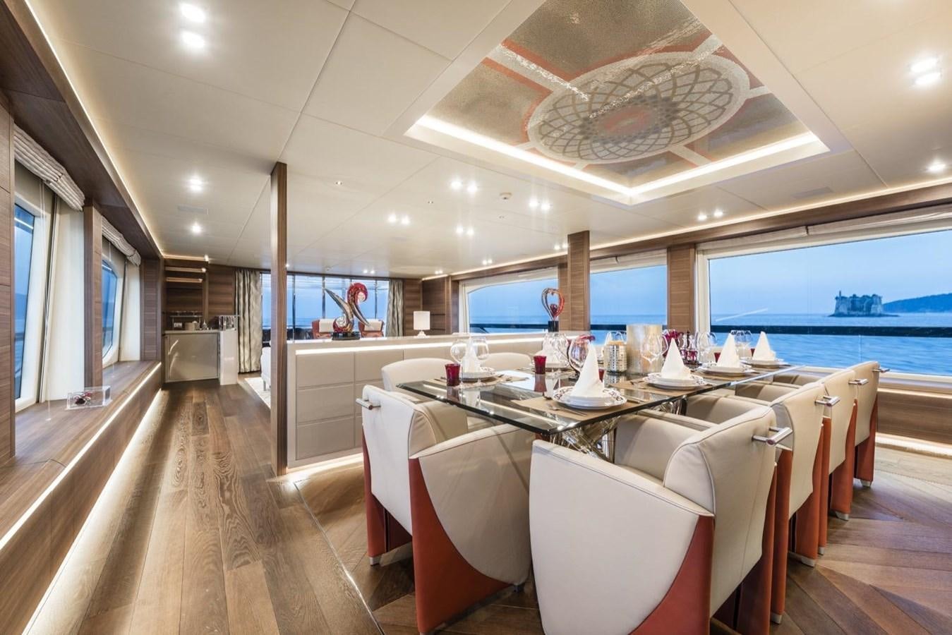 a room with a table and chairs aboard HARMONY Yacht for Sale
