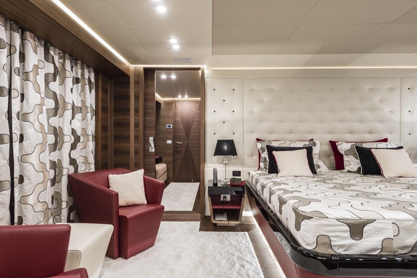 a room with a bed and a chair aboard HARMONY Yacht for Sale
