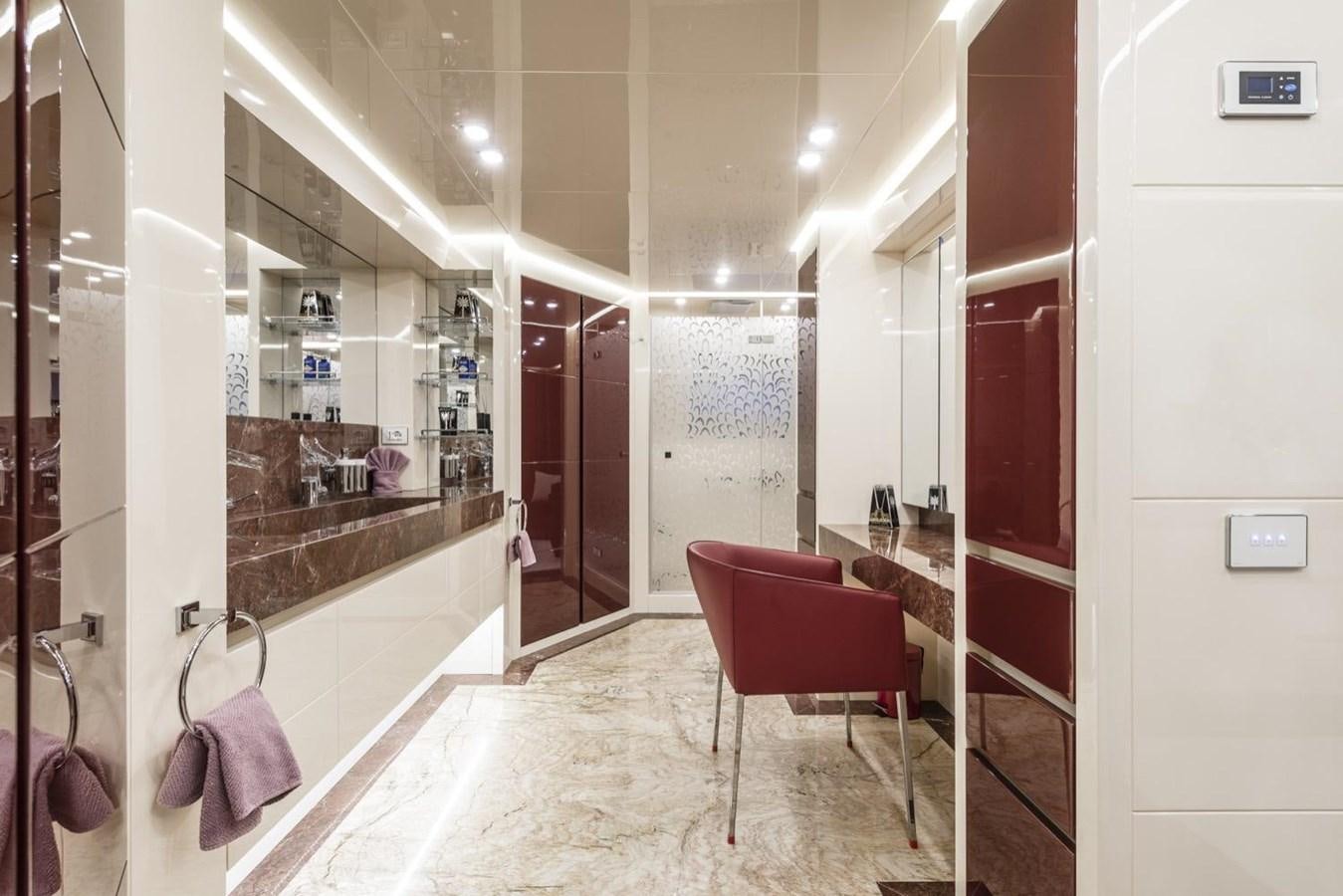 a bathroom with a red chair aboard HARMONY Yacht for Sale