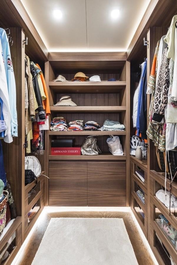 a closet with clothes and clothes aboard HARMONY Yacht for Sale