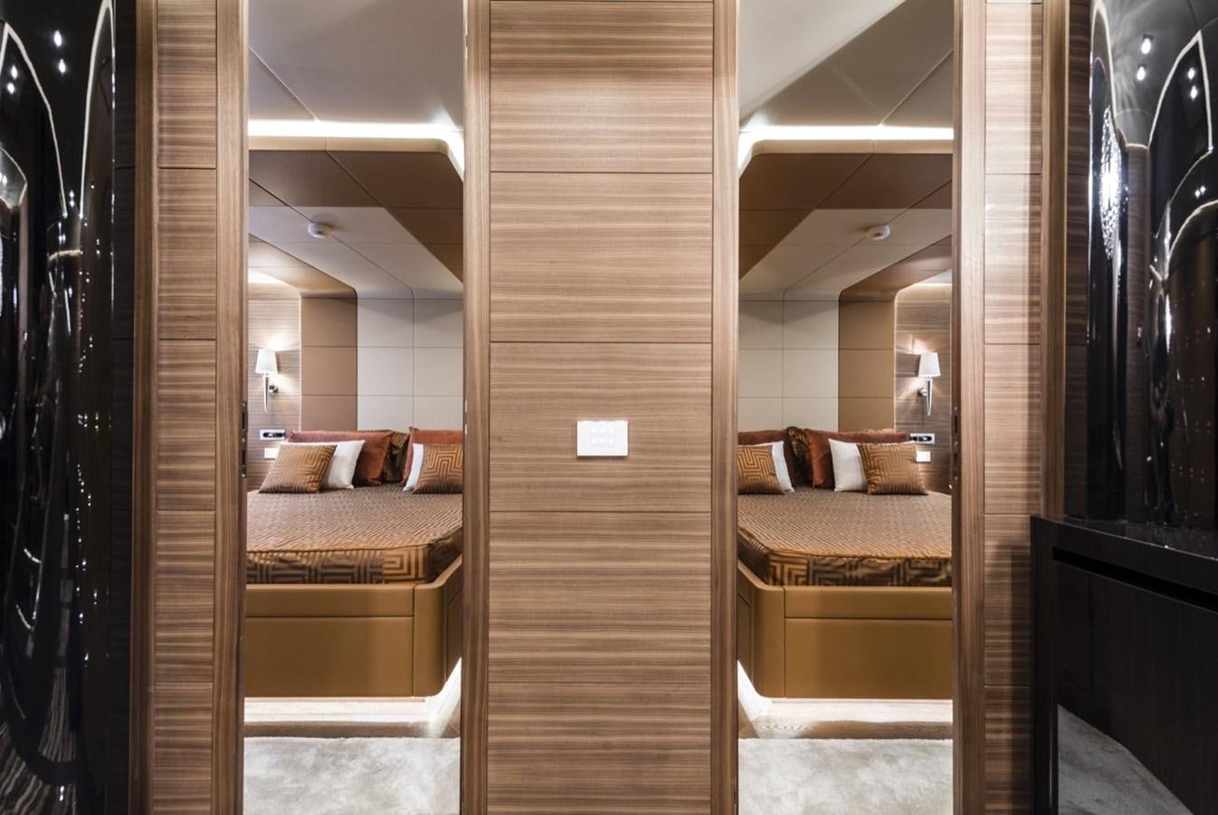 a room with a bed and a mirror aboard HARMONY Yacht for Sale