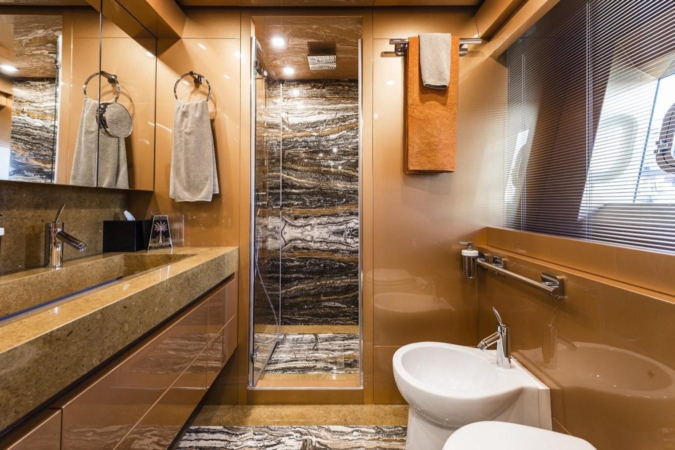 a bathroom with a shower and sinks aboard HARMONY Yacht for Sale