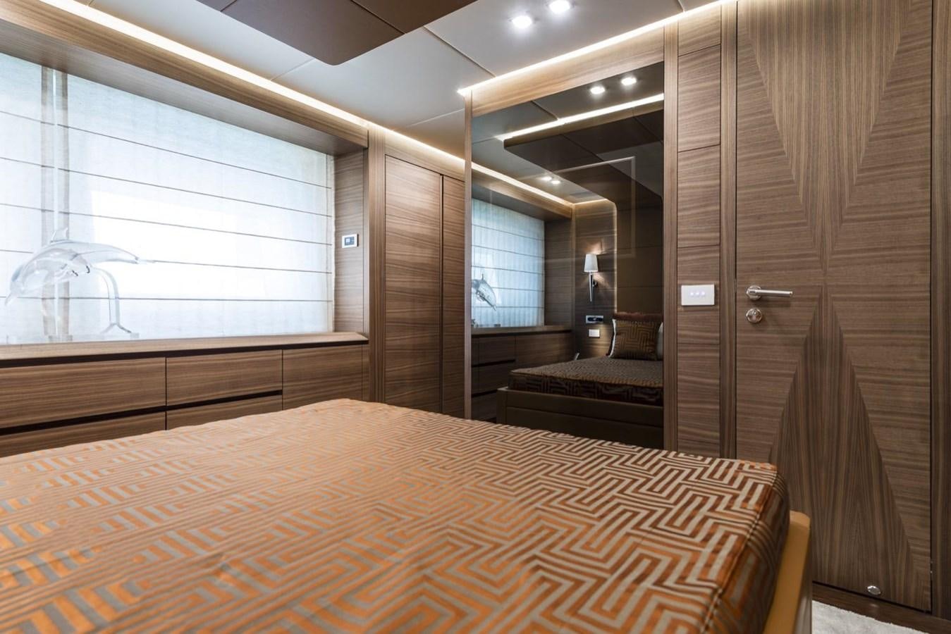 a room with a bed and a window aboard HARMONY Yacht for Sale