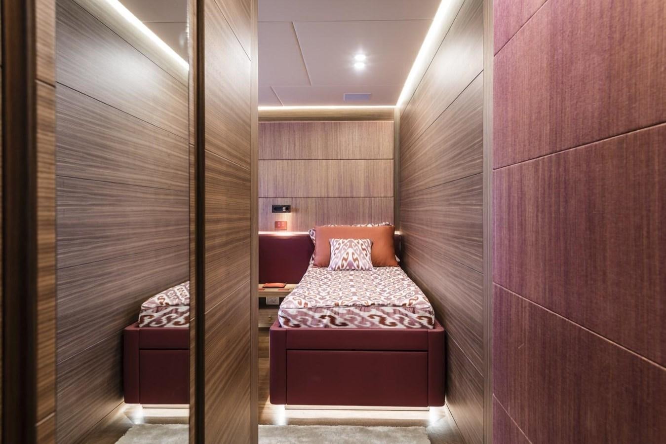 a room with a bed and a mirror aboard HARMONY Yacht for Sale