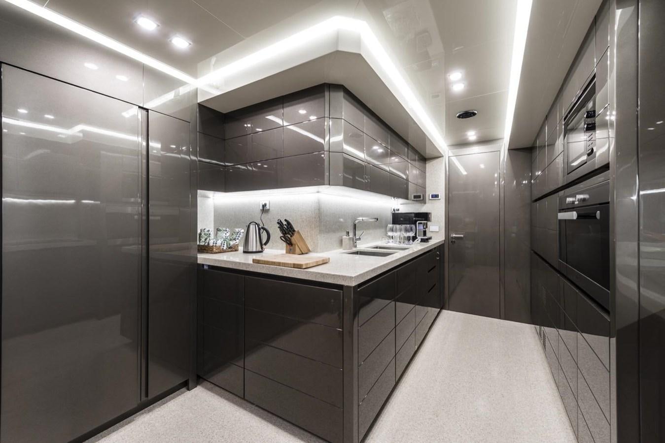 a kitchen with a sink and a refrigerator aboard HARMONY Yacht for Sale