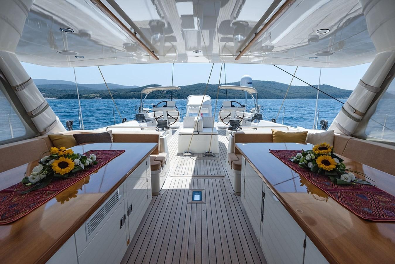 a table with flowers on it aboard LA VICTORIA Yacht for Sale