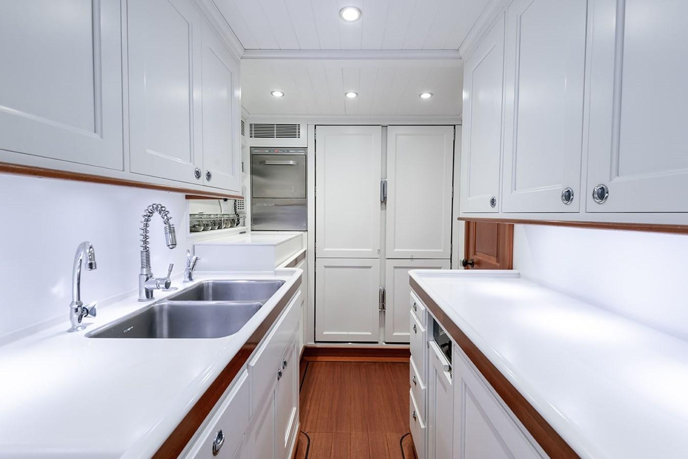 a kitchen with white cabinets aboard LA VICTORIA Yacht for Sale
