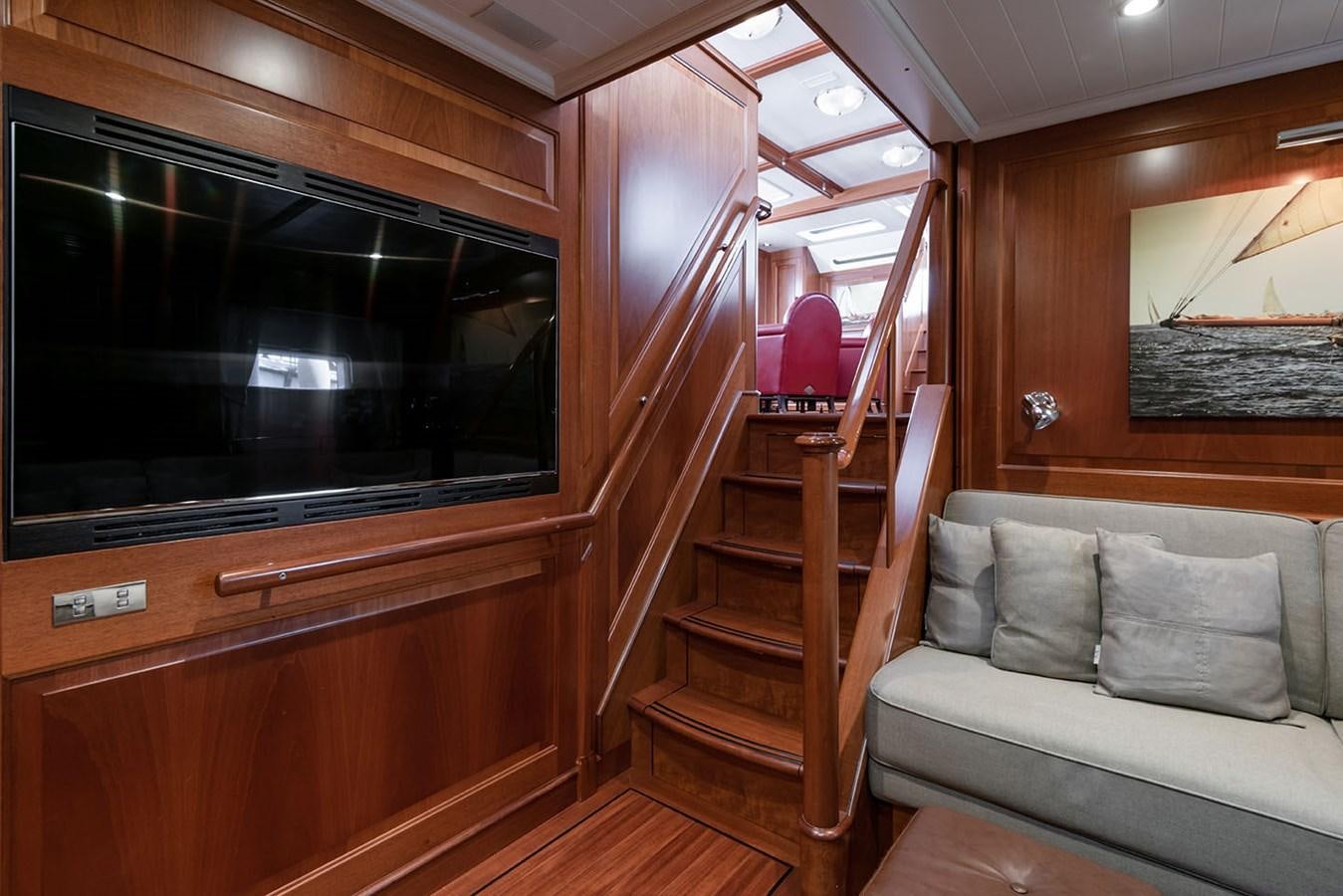 a living room with a couch and a staircase aboard LA VICTORIA Yacht for Sale