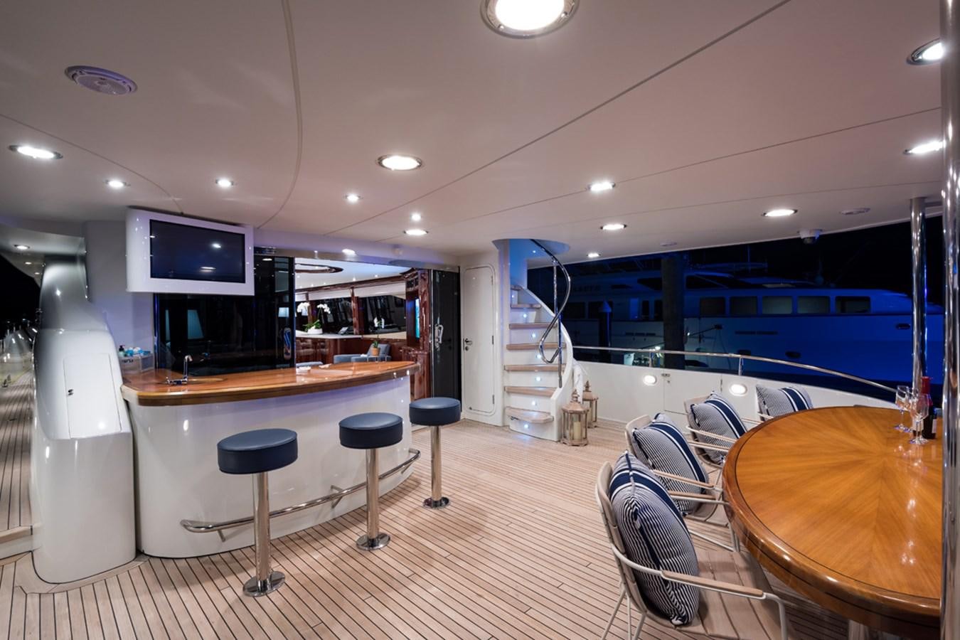 a room with a table and chairs aboard MONEY FOR NOTHING Yacht for Sale