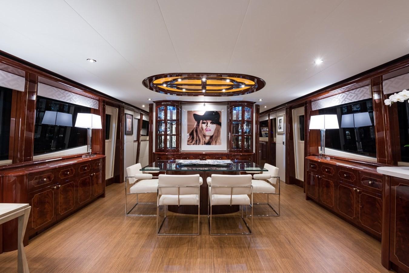a large room with a table and chairs aboard MONEY FOR NOTHING Yacht for Sale