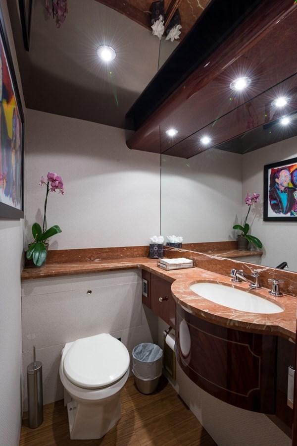 a bathroom with a toilet sink and a mirror aboard MONEY FOR NOTHING Yacht for Sale