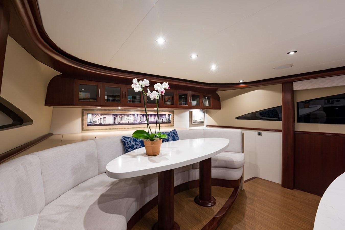 a living room with a table and couches aboard MONEY FOR NOTHING Yacht for Sale