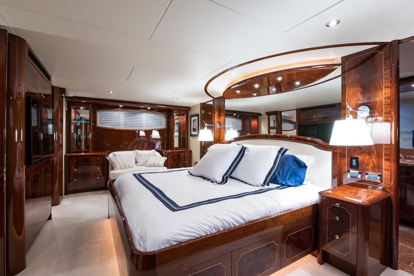 a bedroom with a bed and a desk aboard MONEY FOR NOTHING Yacht for Sale