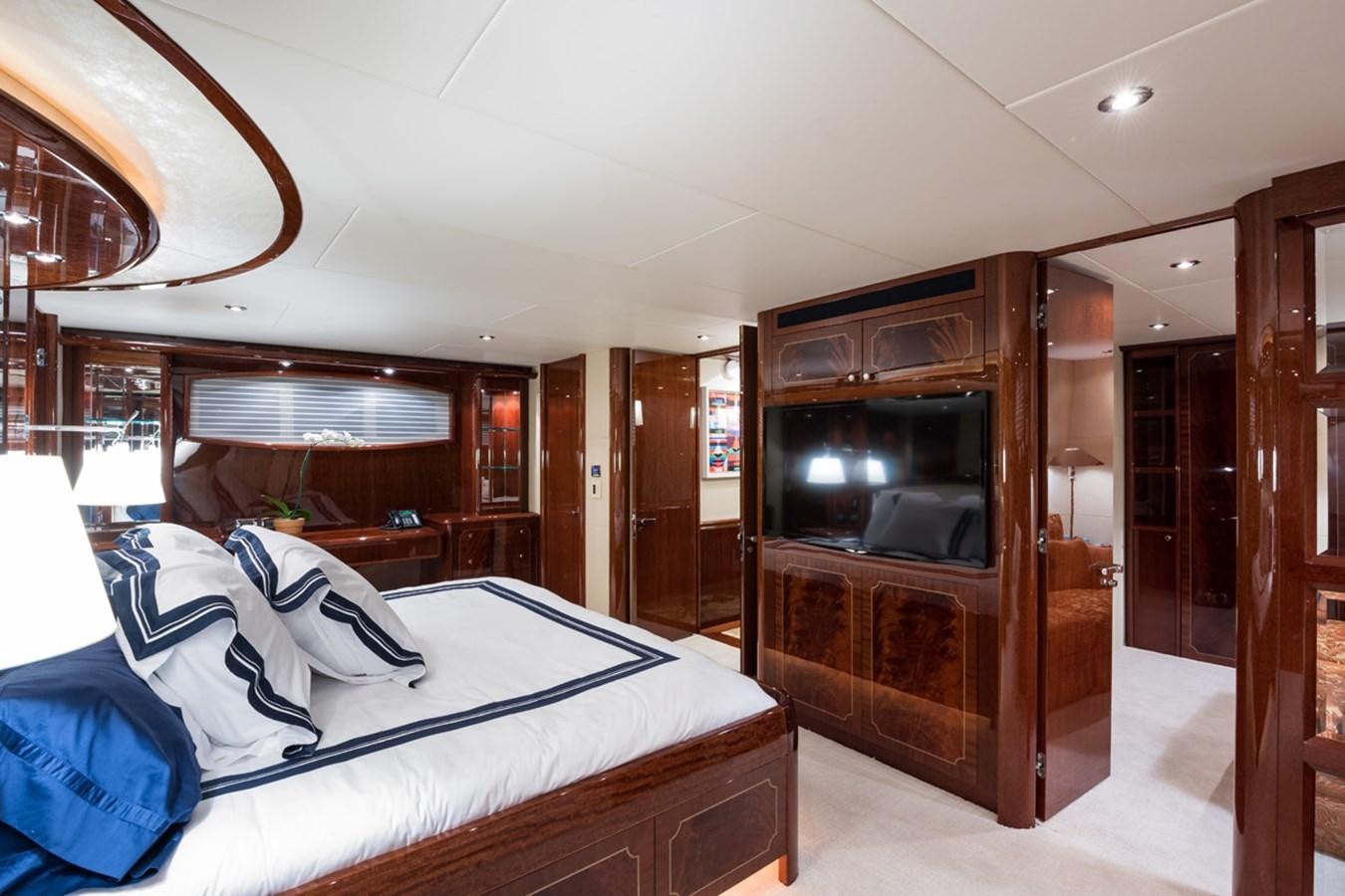 a bedroom with a bed and a television aboard MONEY FOR NOTHING Yacht for Sale