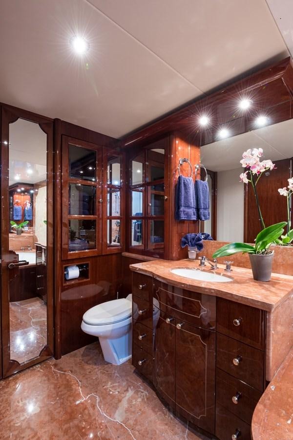 a bathroom with a large mirror aboard MONEY FOR NOTHING Yacht for Sale