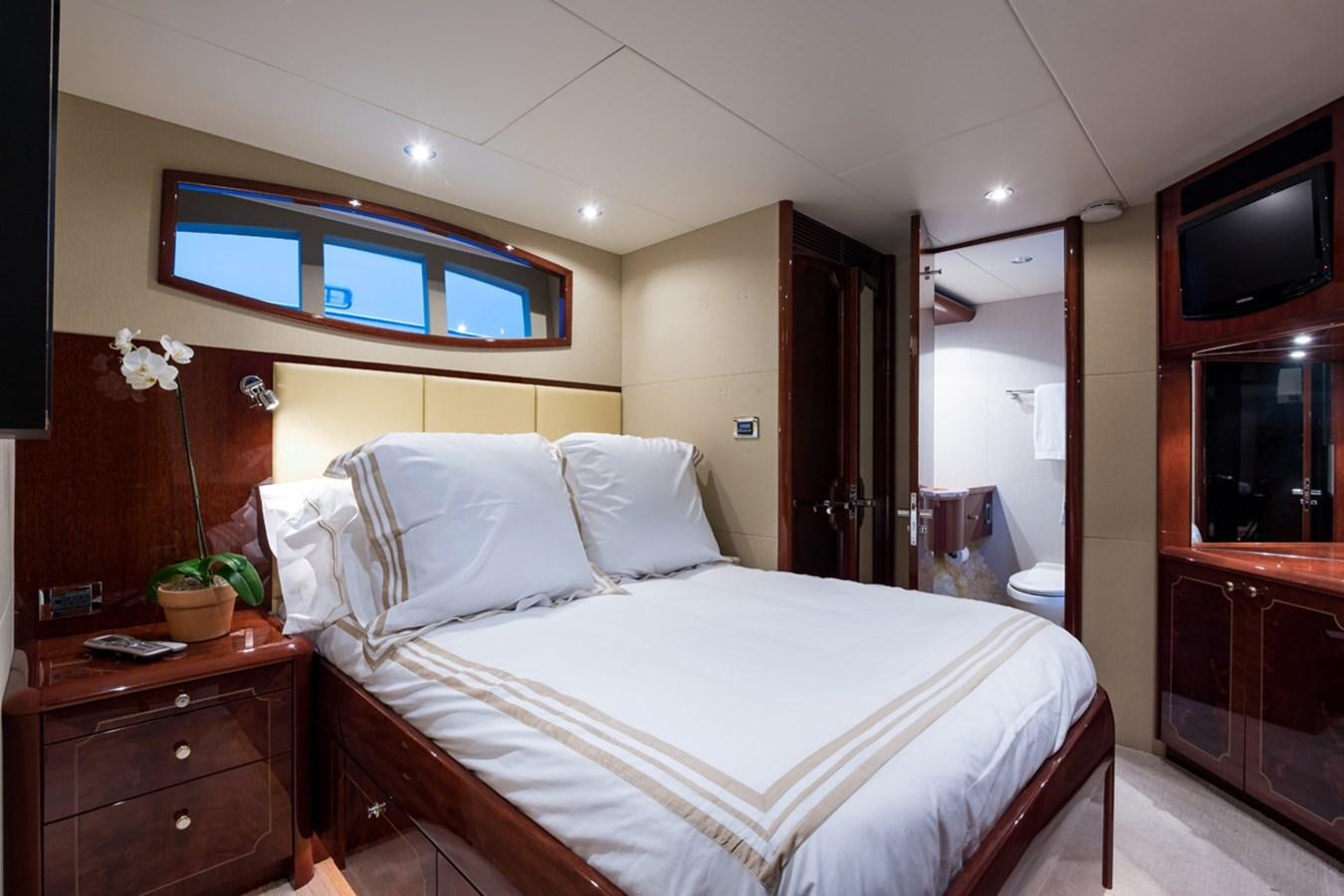 a bed with white sheets aboard MONEY FOR NOTHING Yacht for Sale
