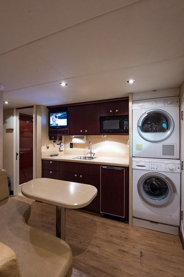 a washing machine and dryer in a kitchen aboard MONEY FOR NOTHING Yacht for Sale