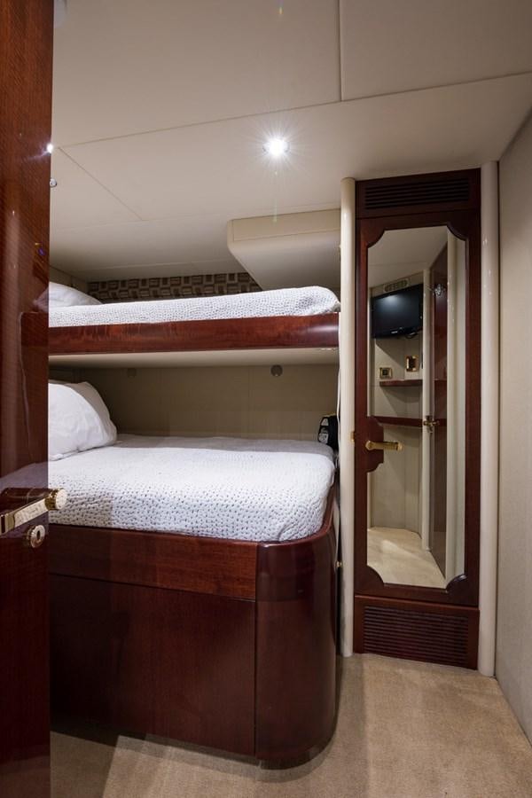 a bed with a mirror above it aboard MONEY FOR NOTHING Yacht for Sale