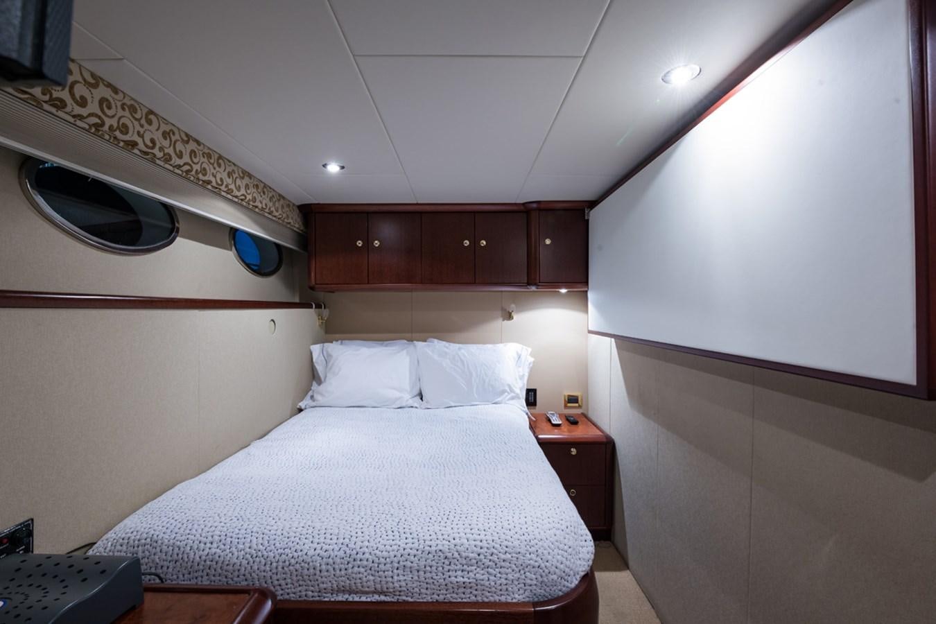 a bedroom with a bed and a microwave aboard MONEY FOR NOTHING Yacht for Sale