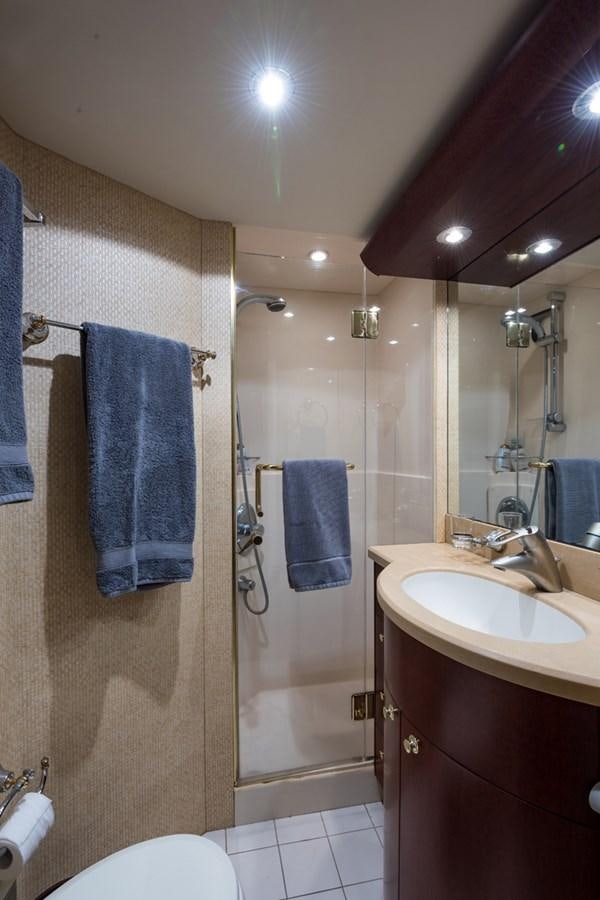 a bathroom with a shower and sink aboard MONEY FOR NOTHING Yacht for Sale