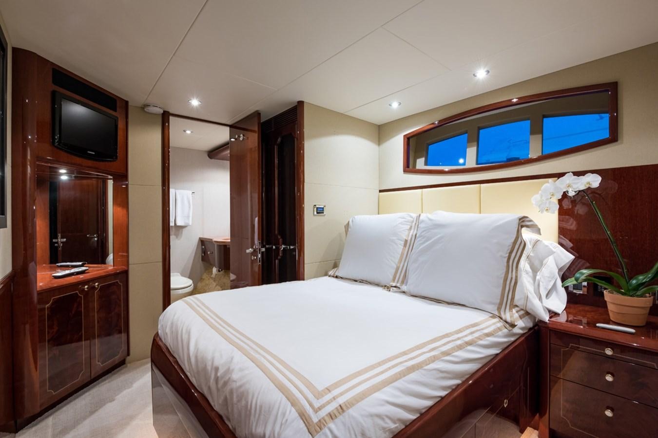 a hotel room with a bed and tv aboard MONEY FOR NOTHING Yacht for Sale