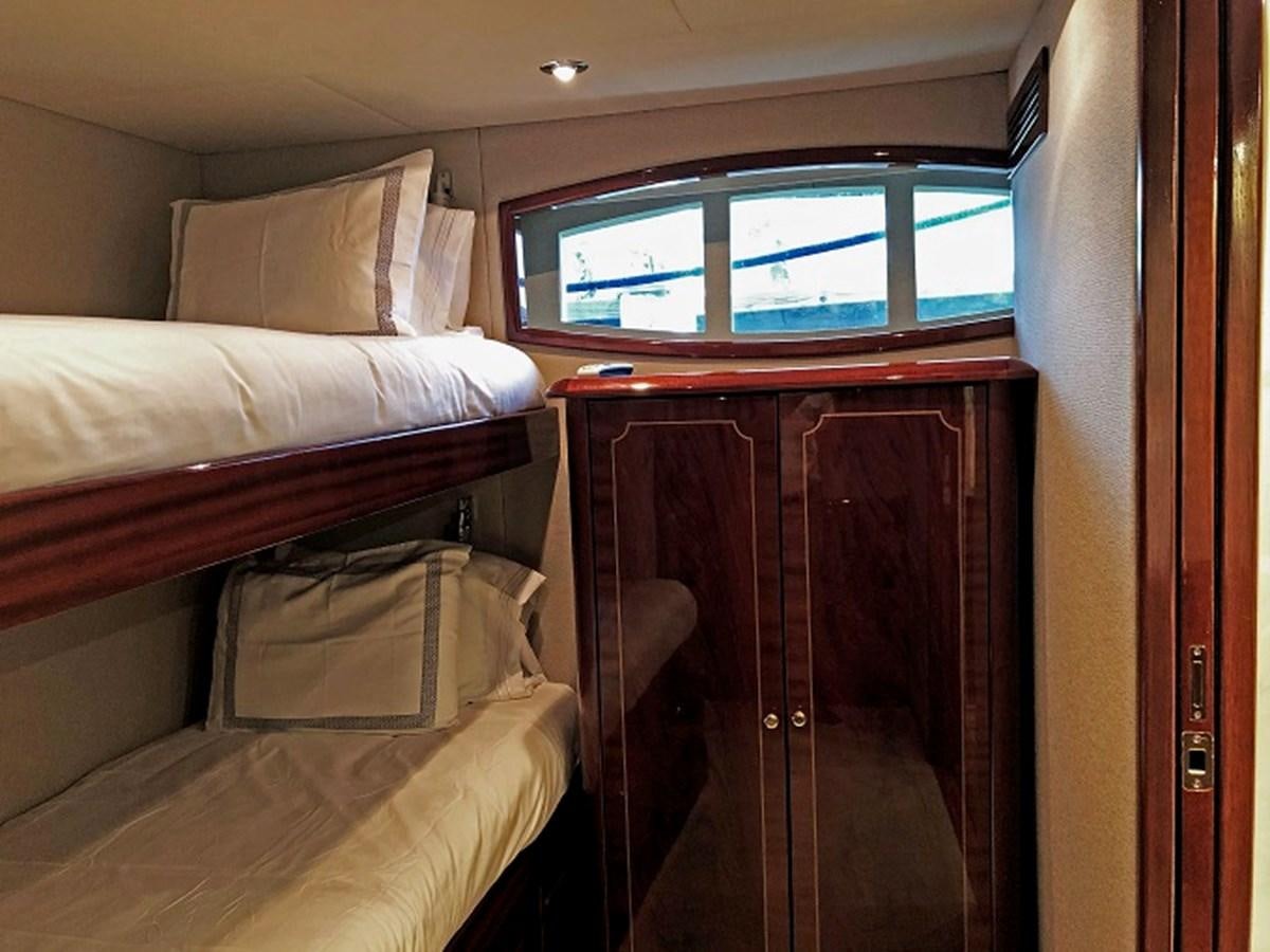 a room with a bed and a window aboard MONEY FOR NOTHING Yacht for Sale