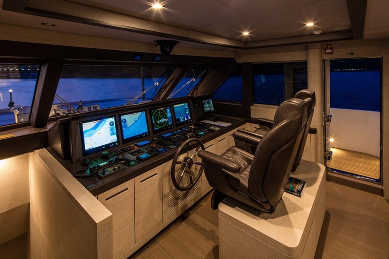 a room with many monitors and a chair aboard OTAM SD35 Yacht for Sale