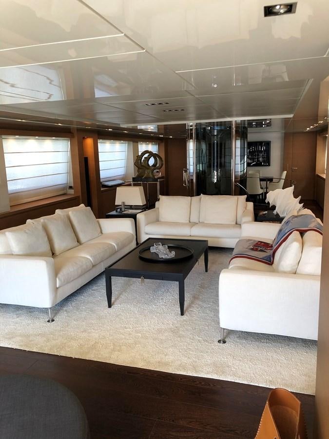 a living room with a table and couches aboard IL GATTOPARDO Yacht for Sale