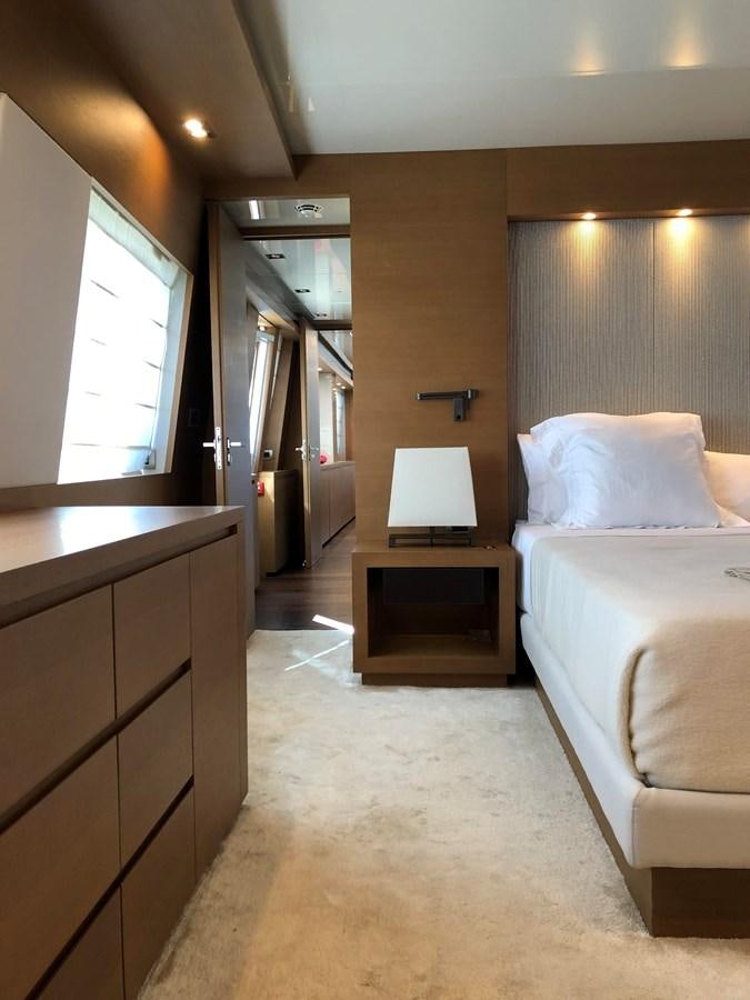 a bedroom with a bed and a desk aboard IL GATTOPARDO Yacht for Sale