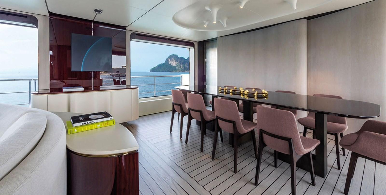 a room with a table and chairs aboard VICIOUS RUMOUR II Yacht for Sale