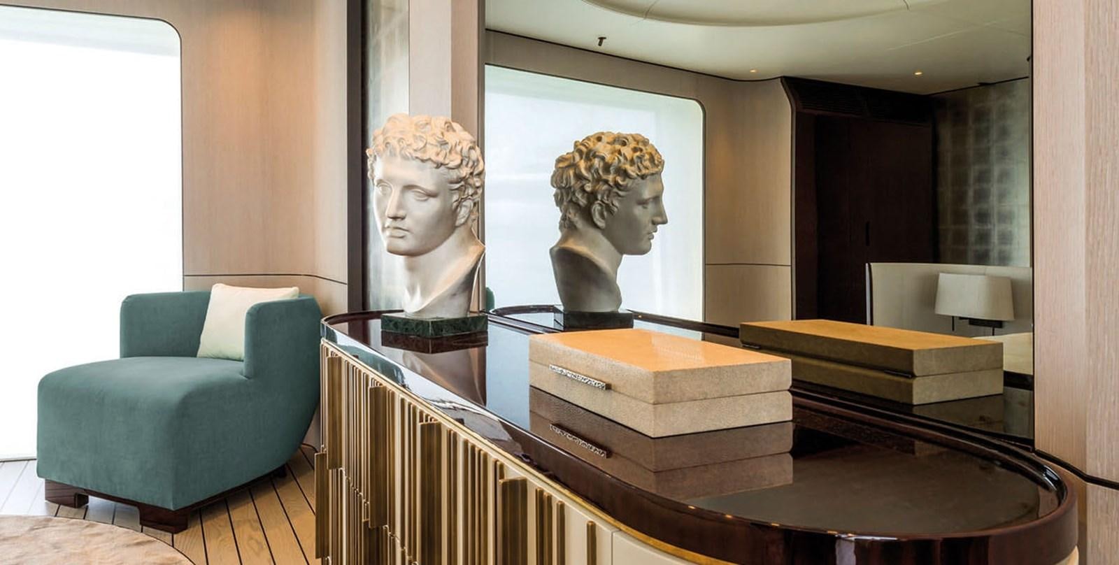 a room with a table and a couch and a painting on the wall aboard VICIOUS RUMOUR II Yacht for Sale