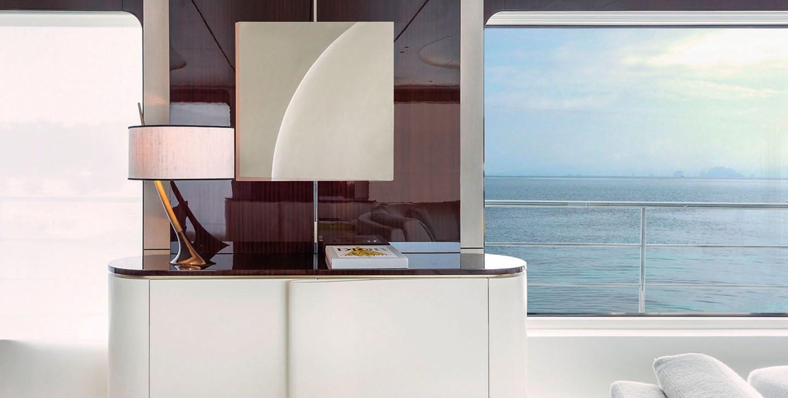 a room with a lamp and a table with a book on it aboard VICIOUS RUMOUR II Yacht for Sale