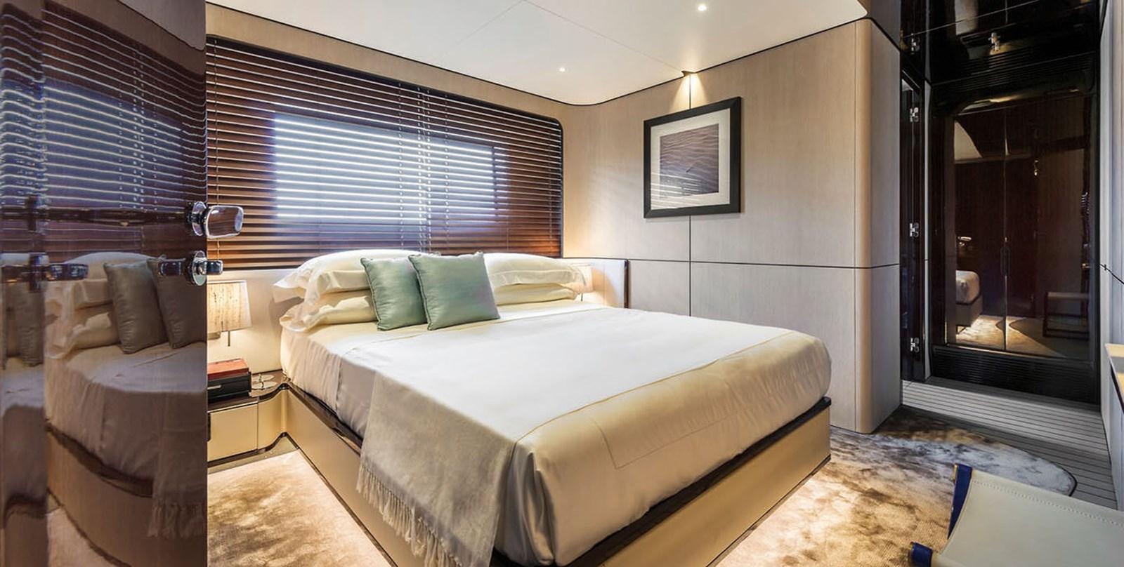 a bedroom with a bed and a chair aboard VICIOUS RUMOUR II Yacht for Sale
