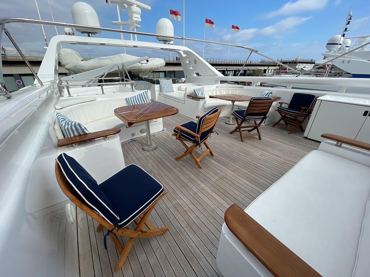 a deck with chairs and tables on it aboard GAUDEAMUS Yacht for Sale
