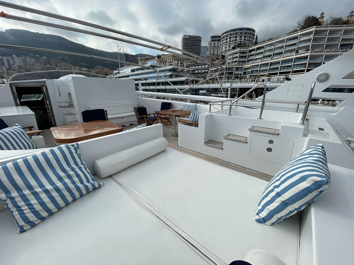 a rooftop of a building with a large white building and a pool aboard GAUDEAMUS Yacht for Sale