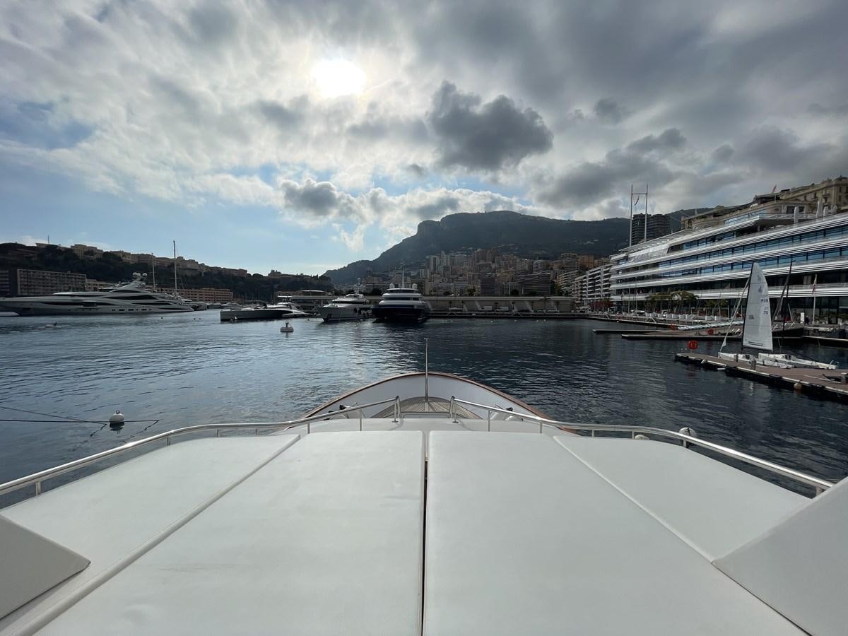 a large white boat in a harbor aboard GAUDEAMUS Yacht for Sale