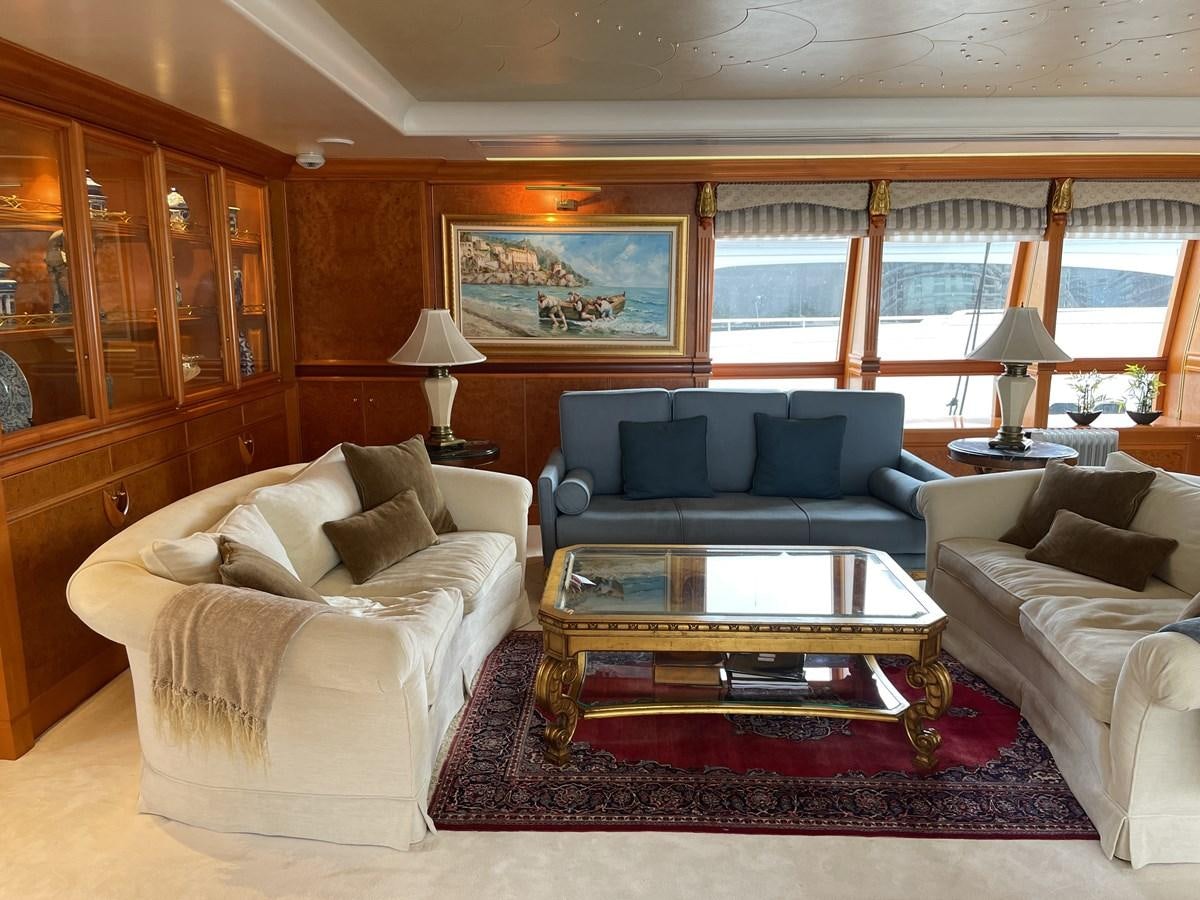 a living room with a couch and a coffee table aboard GAUDEAMUS Yacht for Sale