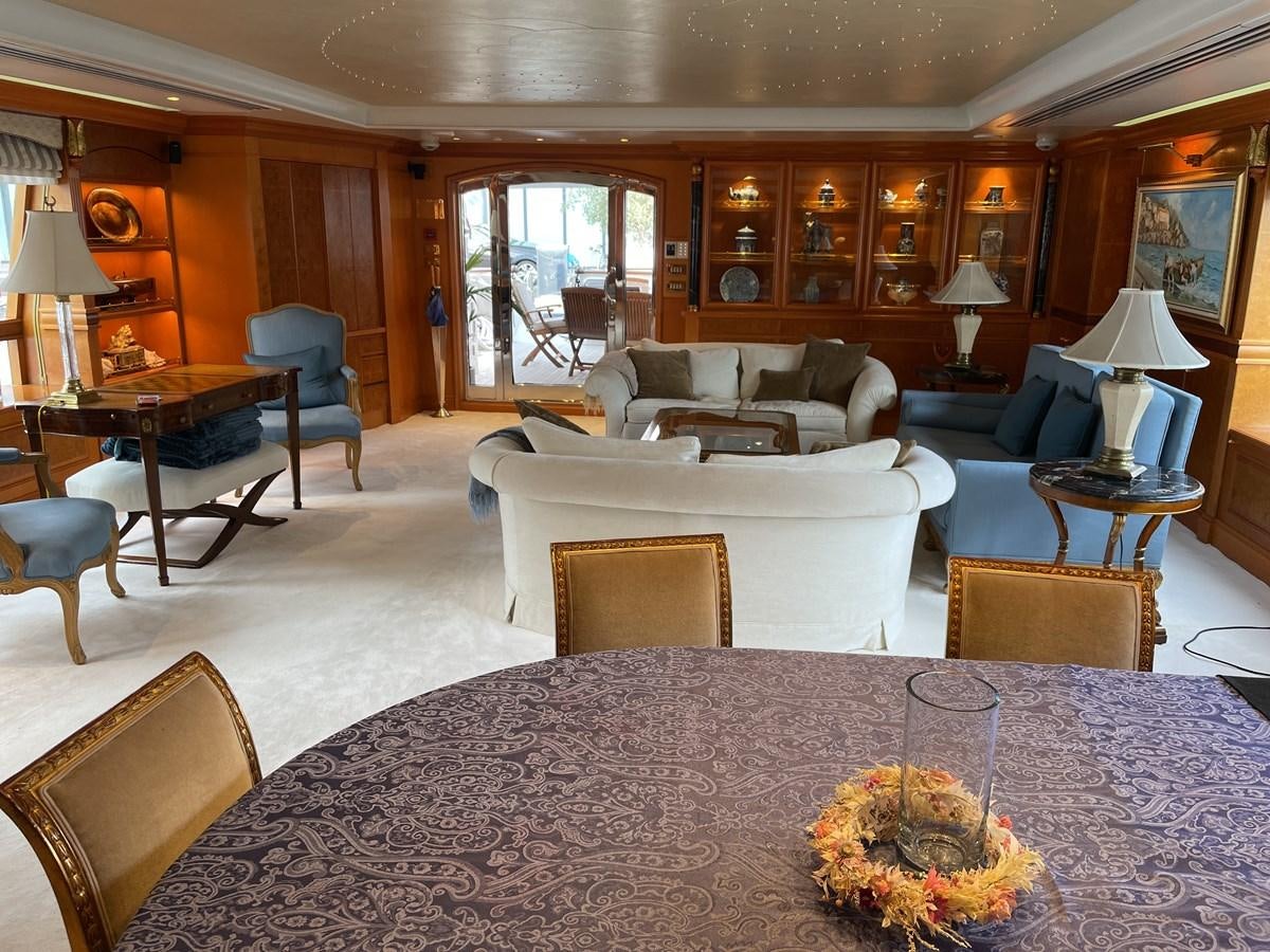 a large living room with a large dining table and chairs aboard GAUDEAMUS Yacht for Sale