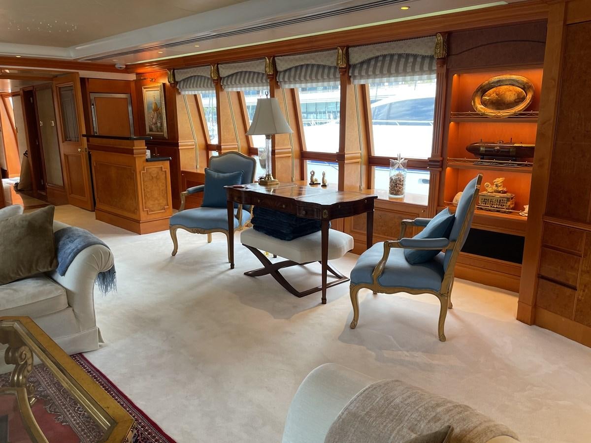 a living room with a table and chairs aboard GAUDEAMUS Yacht for Sale