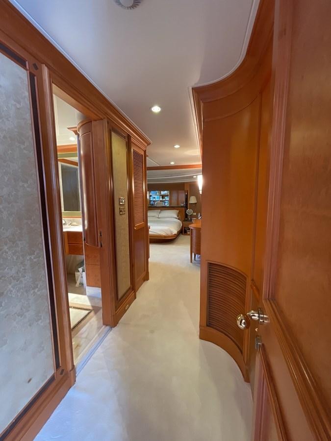 a hallway with a door and a bed aboard GAUDEAMUS Yacht for Sale
