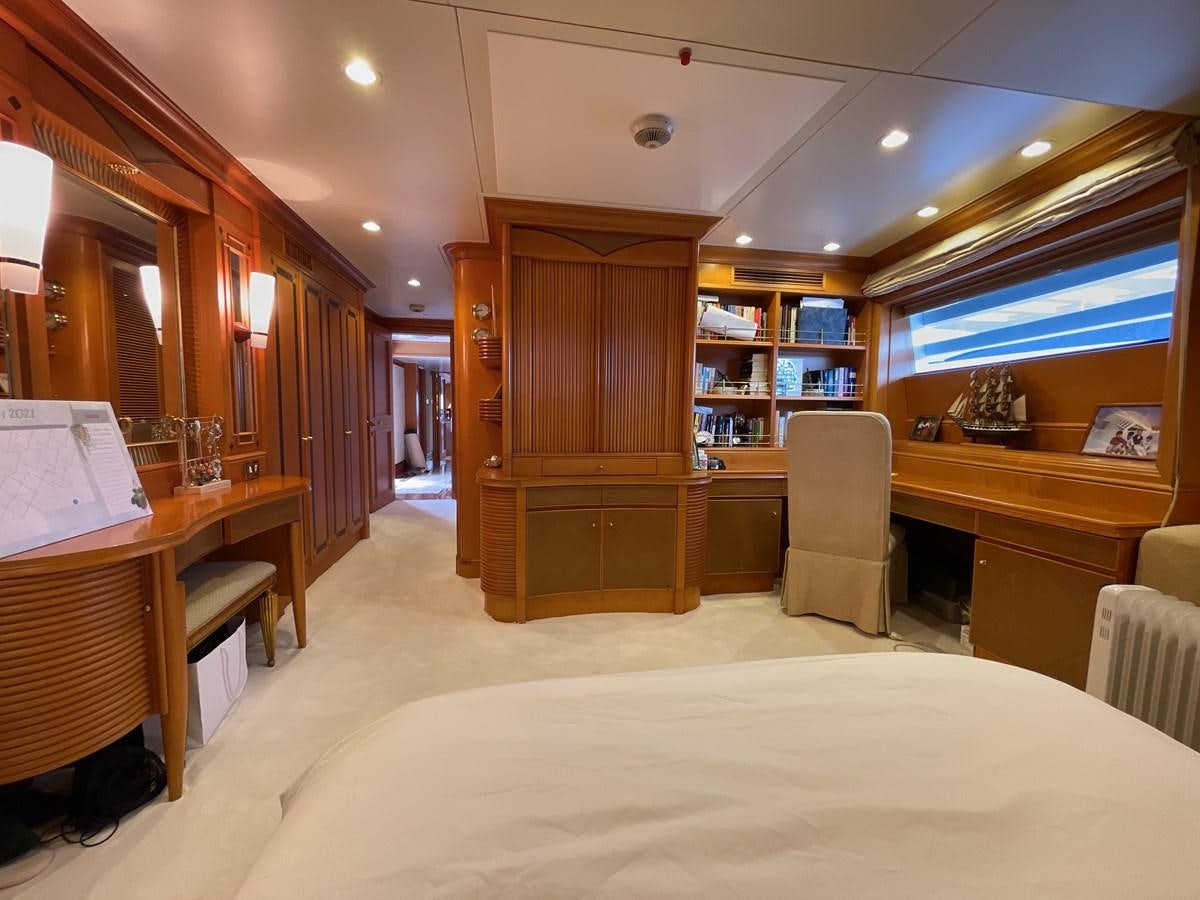 a bedroom with a large mirror aboard GAUDEAMUS Yacht for Sale
