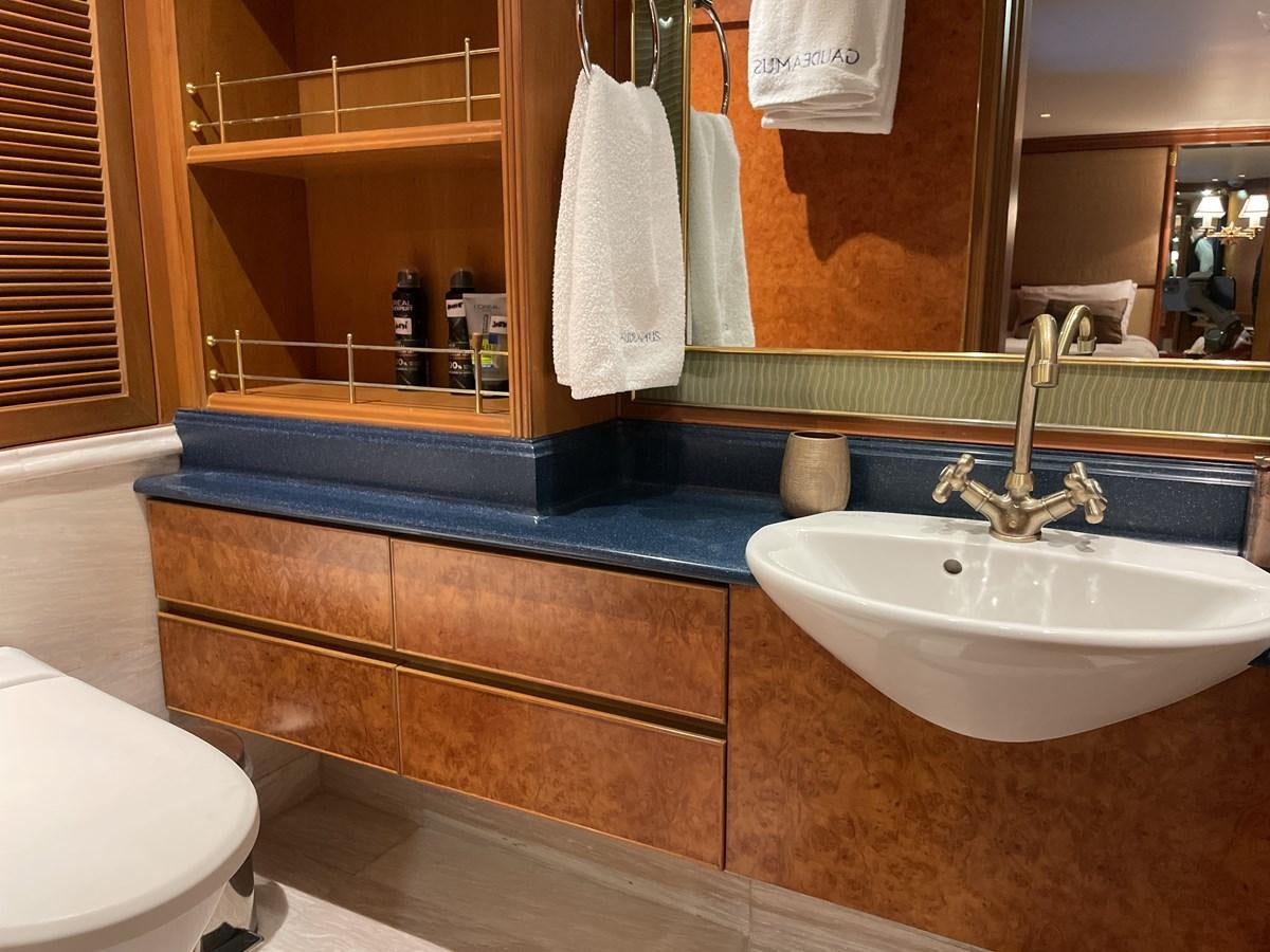 a bathroom with a sink and a mirror aboard GAUDEAMUS Yacht for Sale