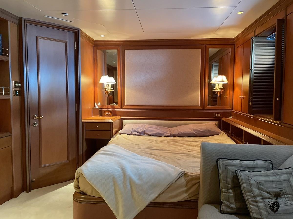 a bedroom with a bed and a desk aboard GAUDEAMUS Yacht for Sale
