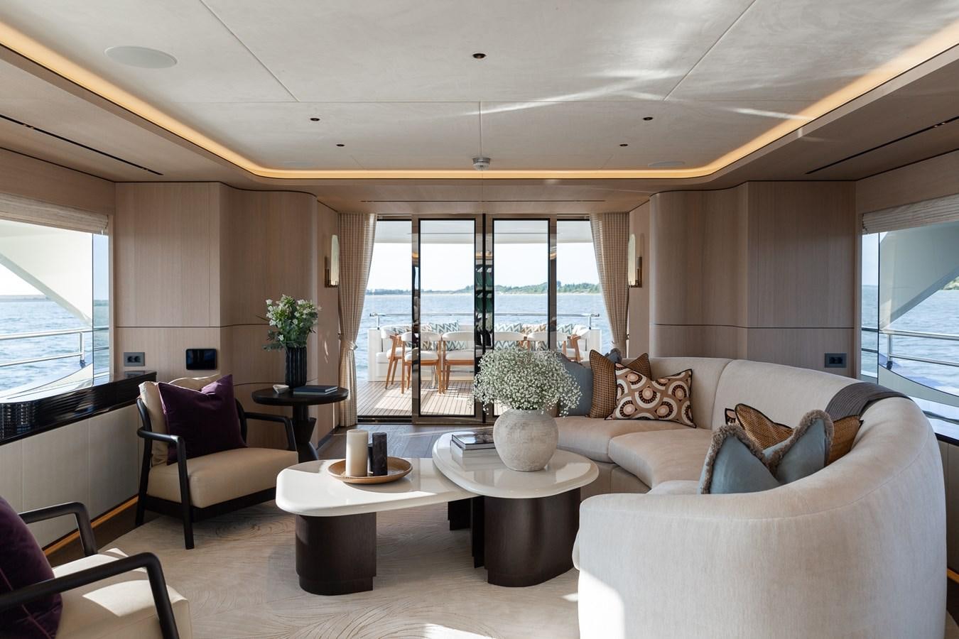 a living room with a large window aboard MOONEN 110 MUSTIQUE Yacht for Sale