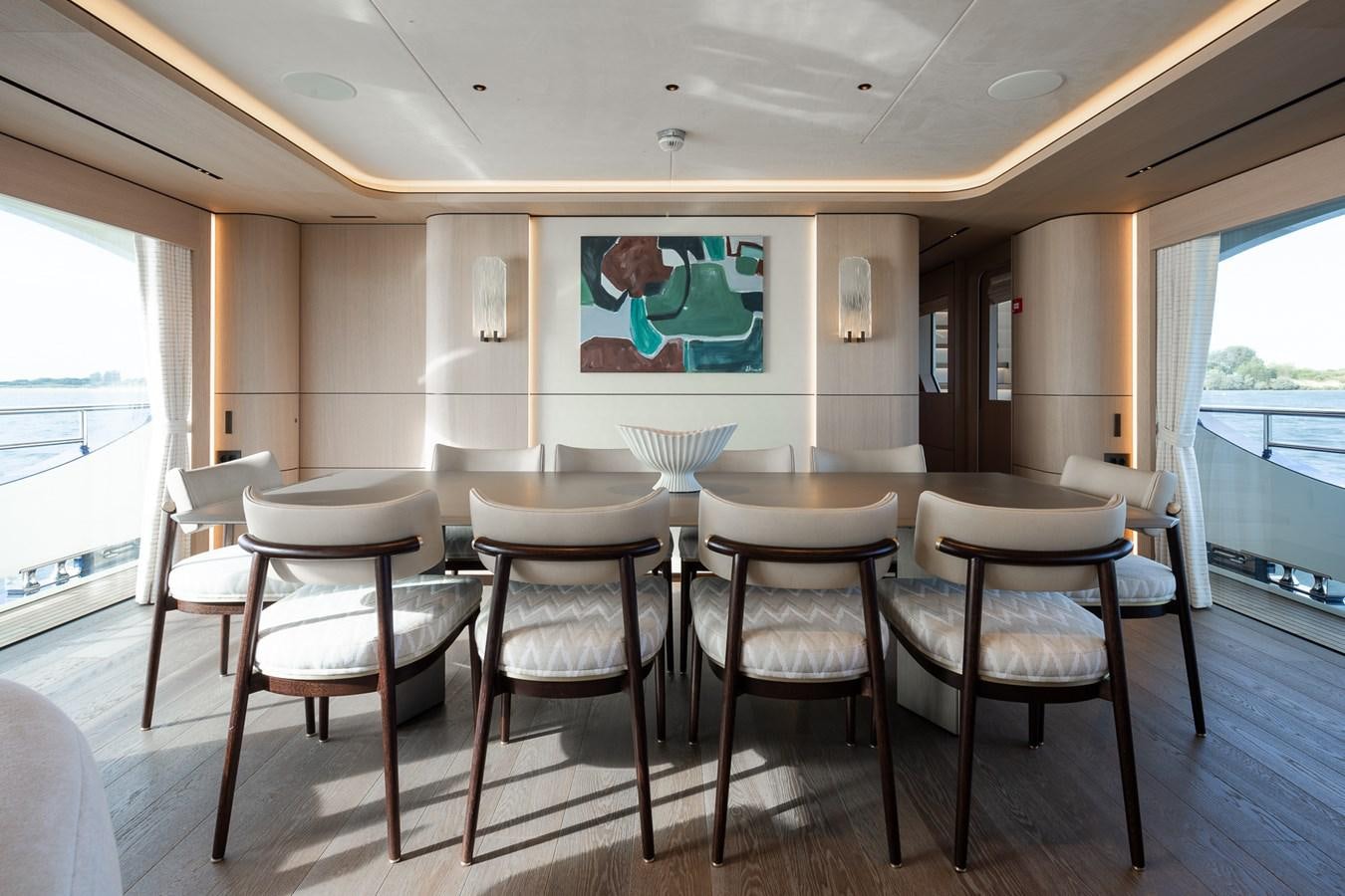 a room with tables and chairs aboard MOONEN 110 MUSTIQUE Yacht for Sale